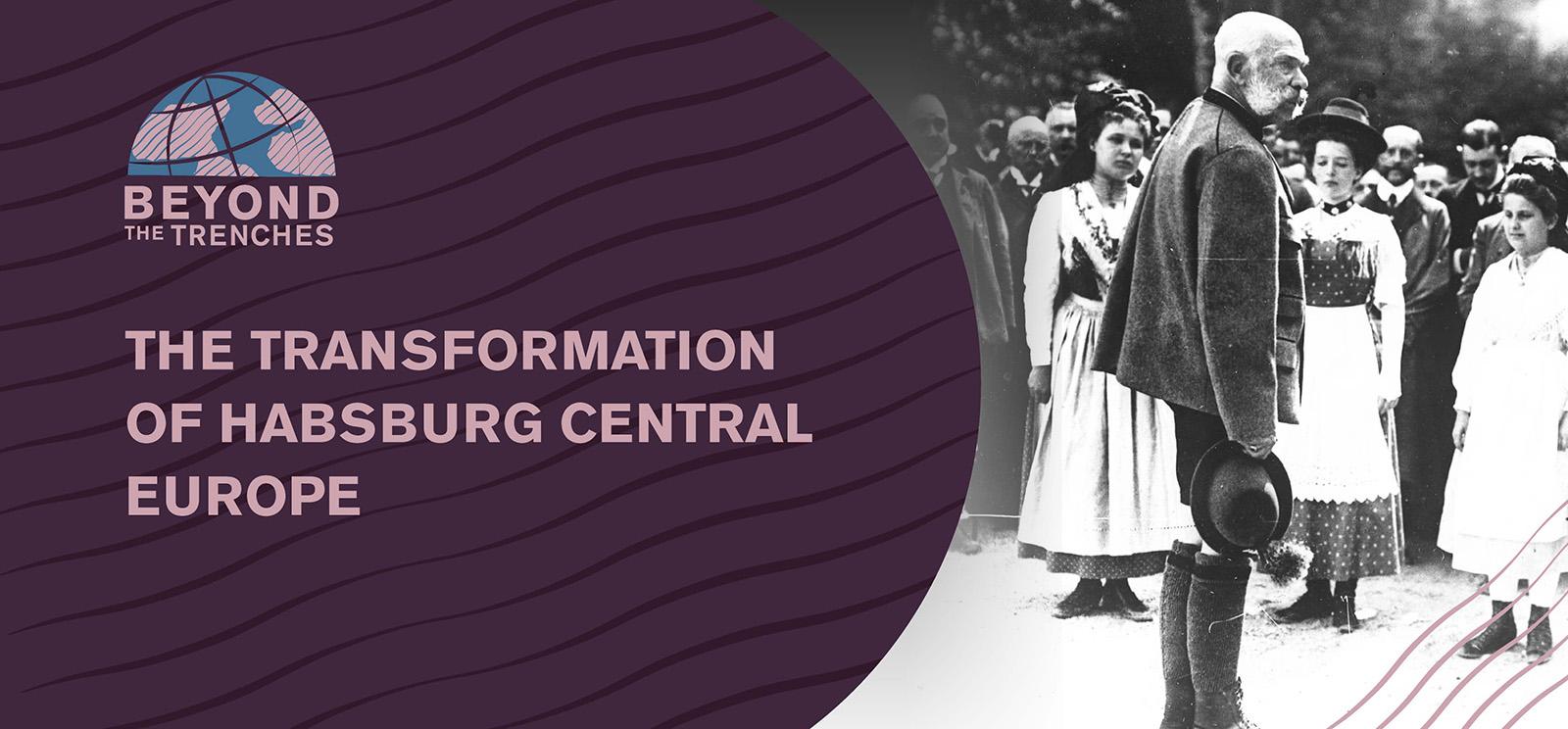 Black and white photo of an older white man with large white muttonchops standing in front of a crowd of people