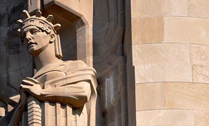 Modern photograph of the side of the Liberty Memorial tower. One of the carved stone Guardians is visible.