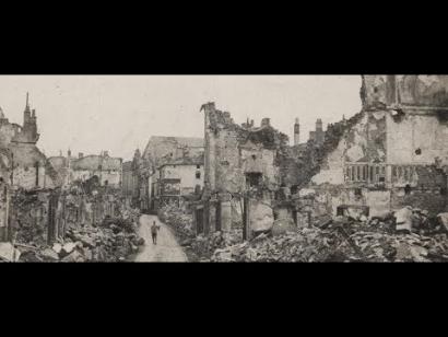 Black and white pphotograph of destroyed buildings in a town.