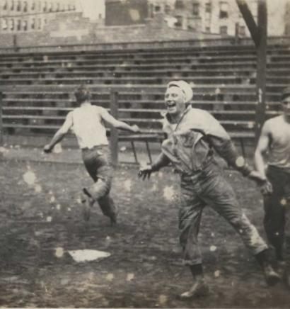 Black and white photograph of men running the bases in a baseball game