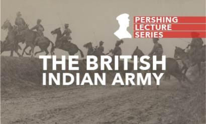 Black and white photo of WWI soldiers wearing turbans, riding horses and galloping across a road