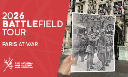Modern photo of an ornate stone façade. Someone's hand is holding up a black and white historical photograph of the same building with troops lined up for inspection by a general.