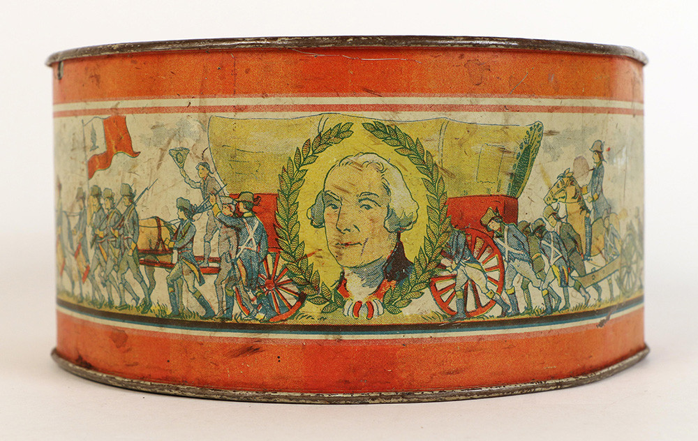 Side view of a toy drum decorated with a portrait of a white man wearing a white wig and images of Revolutionary War soldiers marching